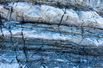 Compressed rock layers formation in various colors and thicknesses, on south central coast of the  Mediterranean island Crete, Greece. Nature and Geological science concept