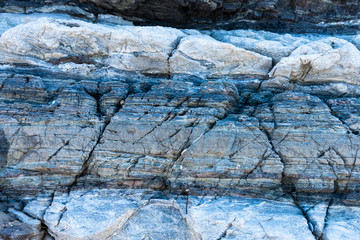 Compressed rock layers formation in various colors and thicknesses, on south central coast of the  Mediterranean island Crete, Greece. Nature and Geological science concept