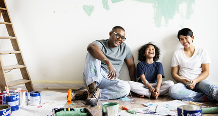 Black family painting house wall