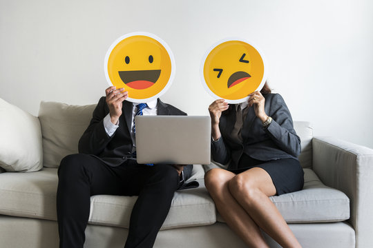 Business couple sitting together with icons