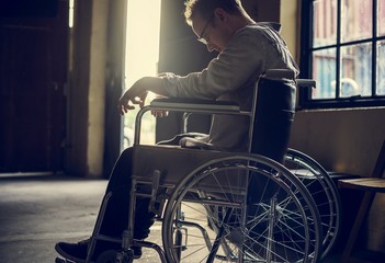 Fototapeta na wymiar Alcoholic man sitting in a wheelchair