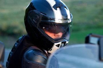 Fototapeta premium close up portrait of rider on a motorcycle - summer road trip on a motorbike