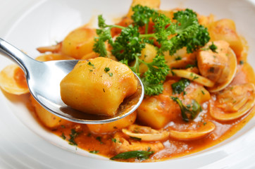 Italian gnocchi with tomato sauce and seafood 