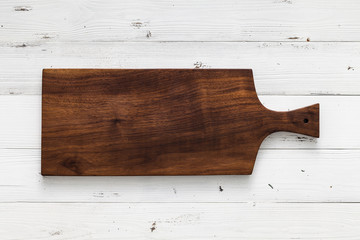 Handmade walnut chopping board on white board, handmade wood cutting board