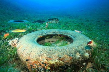 Rubber car tyres pollution on ocean coral reef. Plastic pollutes sea  
