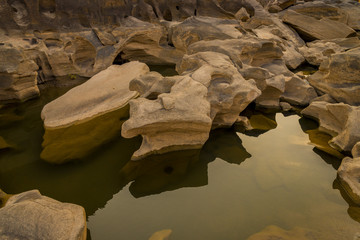 Three thousand waving the rocks beneath the Mekong river. Natural sandstone group Eroded through time for thousands of years.  Ubon Ratchathani, Thailand.