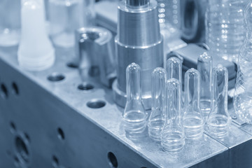 The various type of plastic bottle product with injection mold background in the light blue scene.Drinking container manufacturing processing.