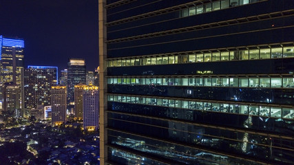 Drone view of office buildings windows at night