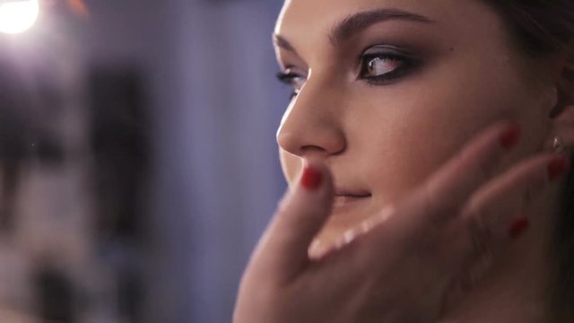 the shading on the cheek girl. makeup artist concealer shade on the cheek and the cheekbone of the model
