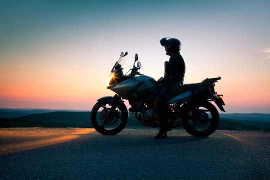 man on his motorbike admiring sunset - summer road trip - space for text © Melinda Nagy