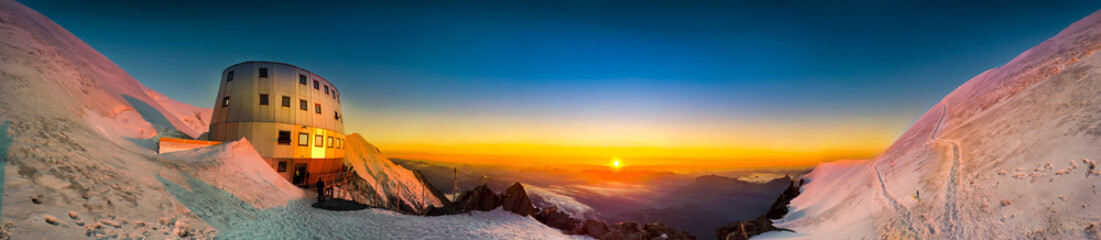 Sunset panoramic view of refuge Du Gouter 3835 m, The popular starting point for attempting the ascent of Mont Blanc , France