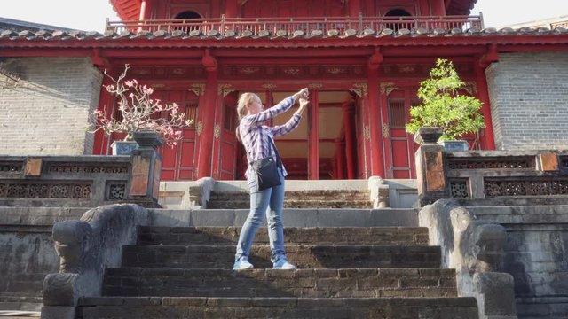 Female tourist taking pictures in the Minh Mang Tomb, Hue