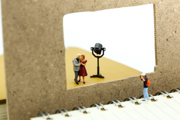 Miniature people : photographer shooting a couple of love.