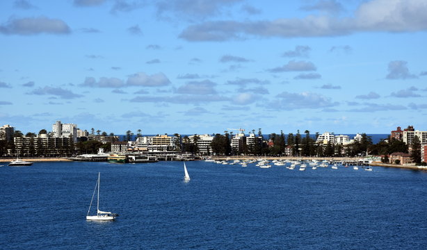 Manly buildings skyline from Dobroyd Head lookout on a sunny day in summer. Many yachts in North Harbour.