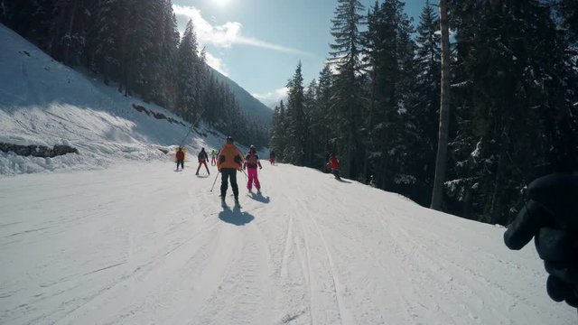 Winter pov of people skiing on slope of famous ski resort Bansko