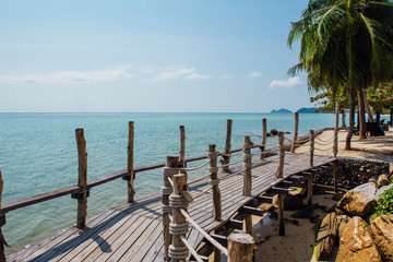 Naklejka premium Paradise beach with wooden bridge