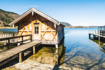 Old wooden house resting over a lake in the morning