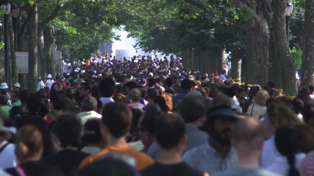 Crowd Walking Away From Camera In A NYC Park