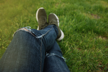 Woman Backpacker Blue jeans Legs Enjoy the View on Green Grass Summer Field