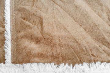 Fototapeta na wymiar beige suede texture with artificial soft fur. closeup shammy background