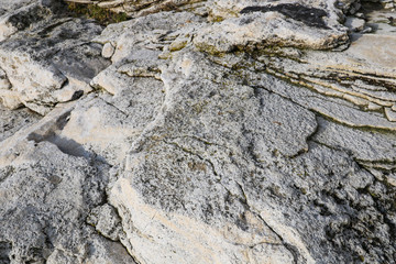 Close-up rough grungy cracked stone texture background. 