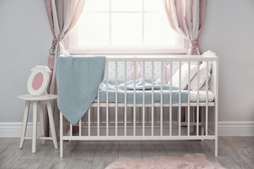 Baby room interior with comfortable crib