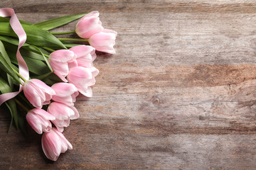 Beautiful tulips for Mother's Day on wooden background, top view