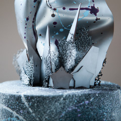 a silver blue decorative cake with chocolate spray and stars 