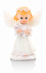 Small plaster angel with blonde hair and white clothes. Holding small sheep in her hands. Isolated on white background with shadow reflection. Symbol of Easter. Small cherub with baa-lamb.