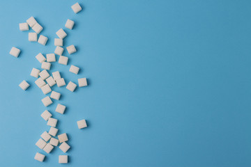 A lot of sugar cubes on a blue background.