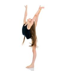 Fototapeta premium The gymnast balances on one leg.
