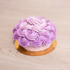 Obraz na płótnie Canvas birthday concept - purple cake on wooden table