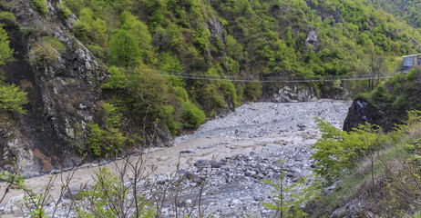 Suspension bridge over the river in the mountains