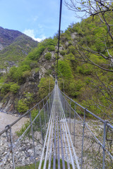 Suspension bridge over the river in the mountains