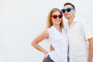 Man and woman wearing heart shape sunglasses