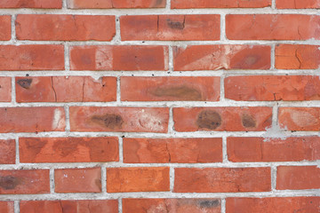 Red brickwork with different defects, shabby texture