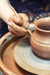 Ceramics. The master at the potter's wheel produces a vessel of clay, decorating.
