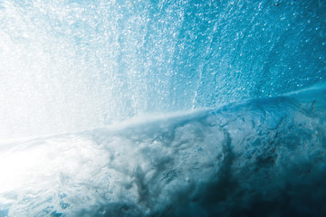 Underwater wave in sea and sun rays. Water texture in ocean