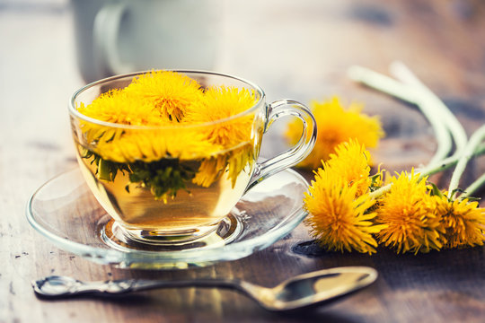 Cup of dandelion tea on rustic wooden table