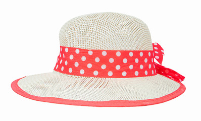 Summer woman's beach hat with pink dotted ribbon. Isolated on white background. Sun protective womanish sunbonnet. Harvest hat against heat. Field hat against strong sunrays. Sun hat with holes. © peter