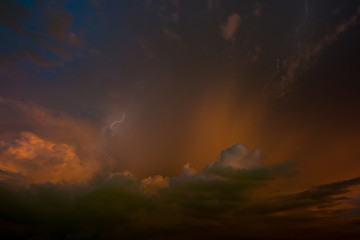Stroke of lightning with storm clouds