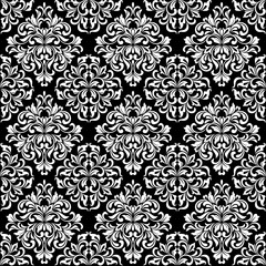 Luxurious seamless pattern. White ornate Damask ornament on a black background. Elegant tracery from swirls and foliage. Ideal for textile print and wallpapers.