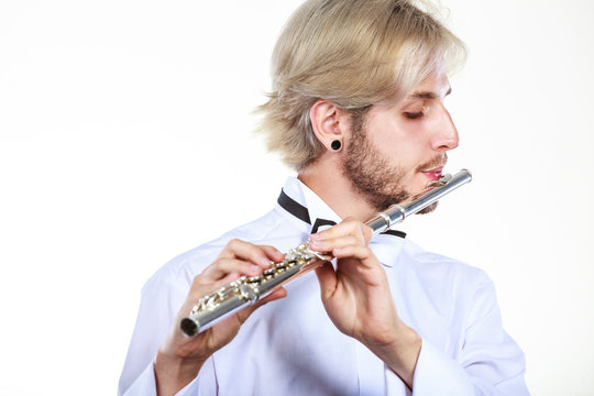 Male flutist playing his flute