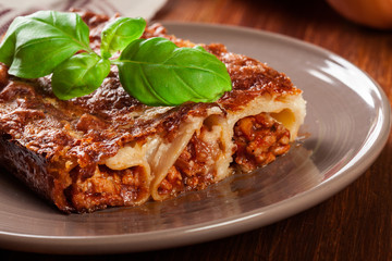 Baked cannelloni with minced meat and bechamel sauce on a plate