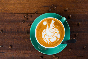 latte coffe art with wooden background
