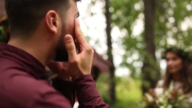 Trembling moment the groom when seeing the bride is crying