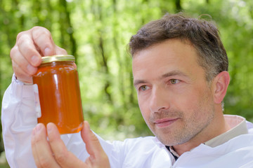 Fototapeta premium beekeeper checking the honey
