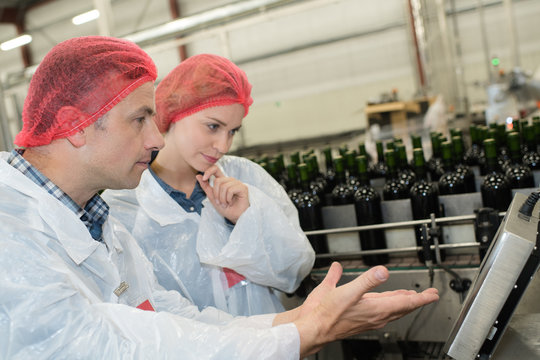 Workers In Glass Bottle Factory