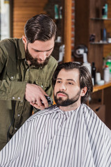 barber shaving client with Hair Clipper at barbershop