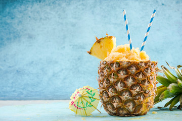 Serving tropical ice granita in pineapple